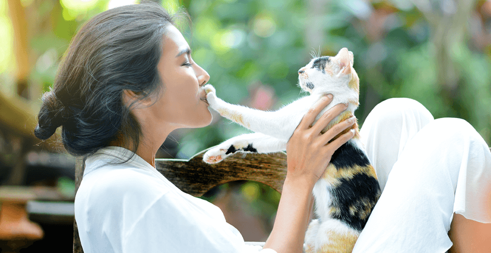 Photo of a woman holding her cat.