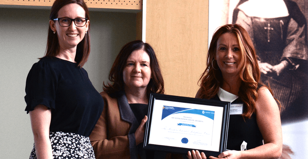 Genetic Counsellor Stephanie Clarke (left) and Dr. Colette Seifer accept the Health Innovation Award on behalf of the Manitoba Inherited Arrhythmia Clinic team from WRHA Chief Health Operations Officer Krista Williams.