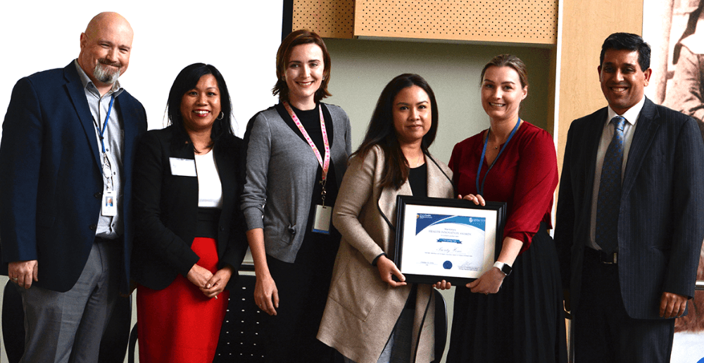 WRHA Chief Health Operations Officer Gina Trinidad (second from left) presents the Health Innovation Award to Priority Home team members Greg Reid, Renae Reiser, Diana Alvaran, Stefanie Turner and Vikas Sethi.