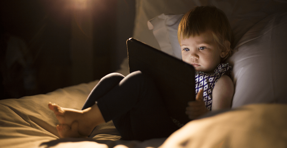 Photo of a young child with an iPad