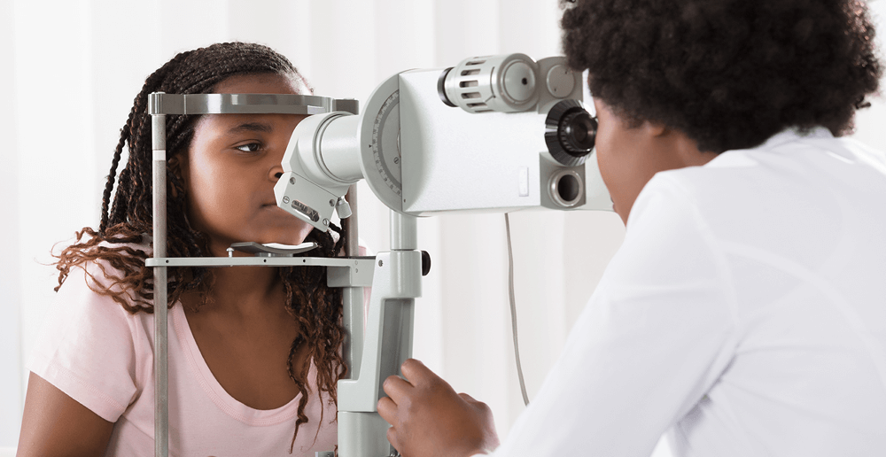 Photo of a young girl getting an eye exam