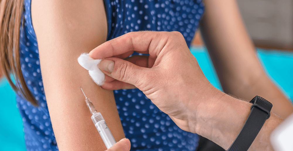 Photo of a young girl receiving a vaccine