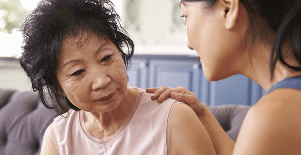 Photo of a woman comforting her elderly mother